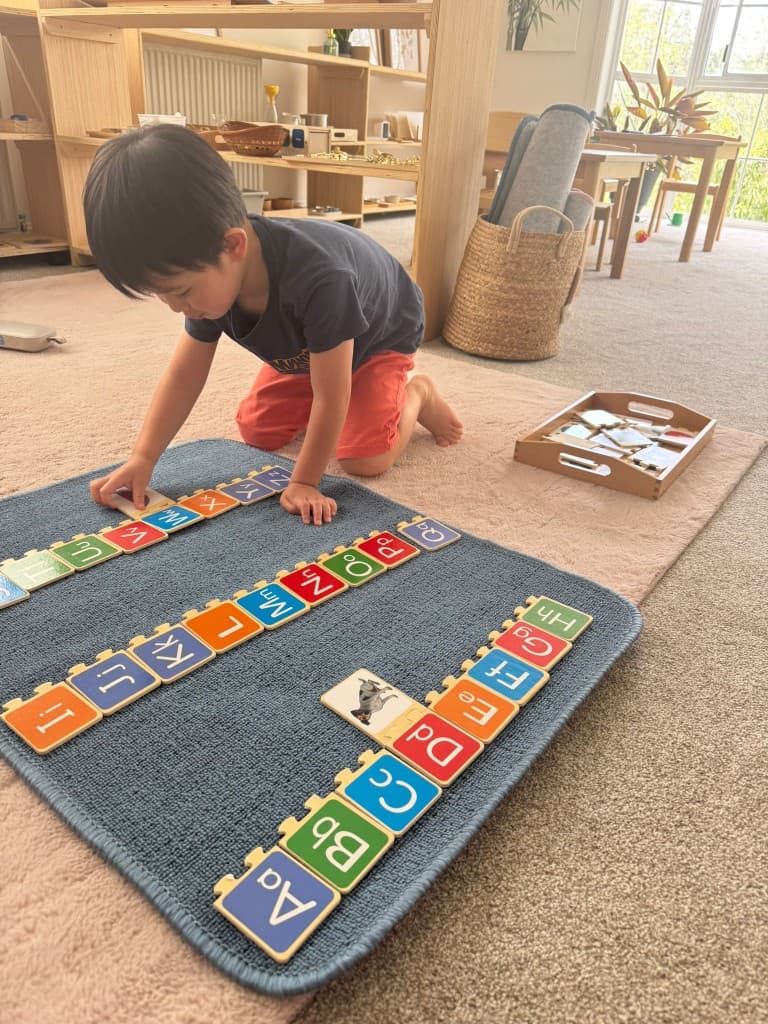Arranging alphabet tiles on a mat
